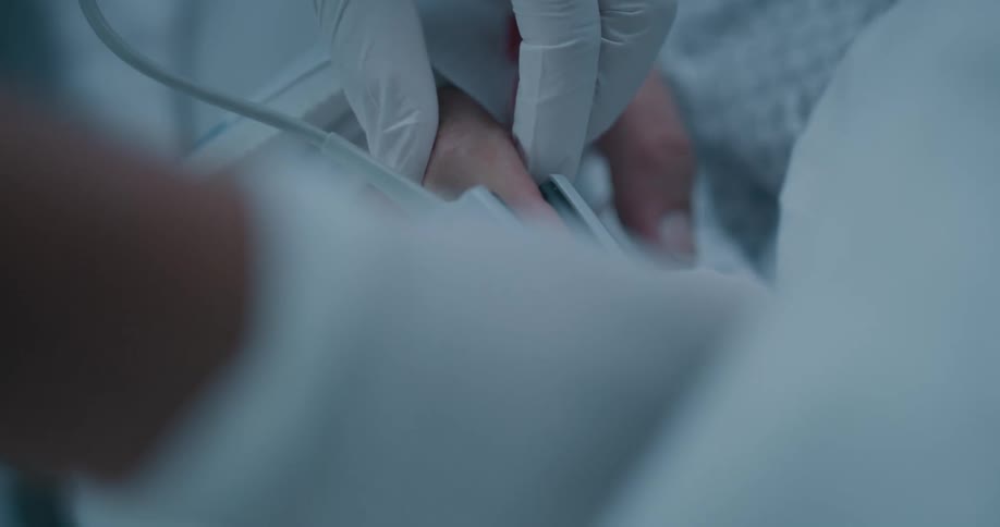 A person putting a heart rate monitor on someone elses hand