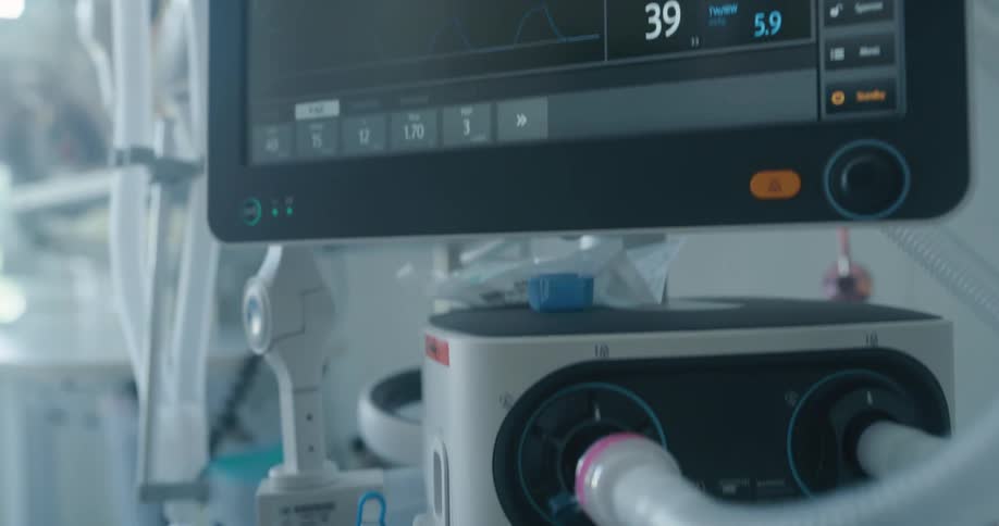 A medical machine with a computer display and pipes coming out of it