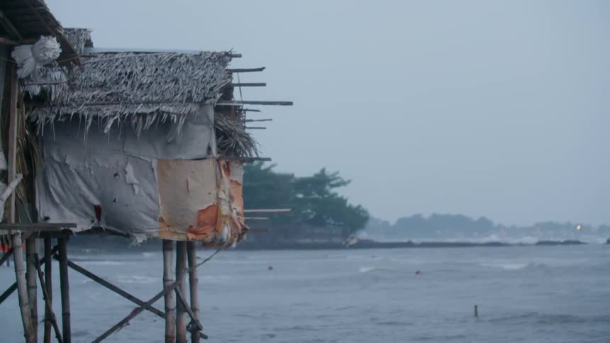 A hut elevated over rough ocean waters