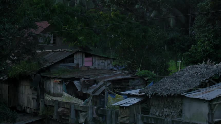 Moving past a row of huts in a field