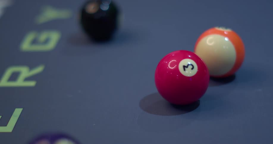 Billiard table with organized 8 balls get hit and scatter across the table
