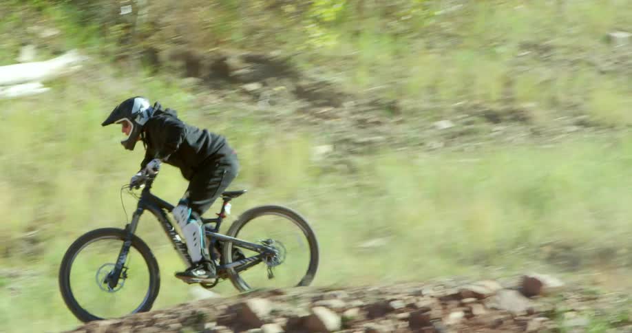 Man driving a cross country mountain bike on a dirt track