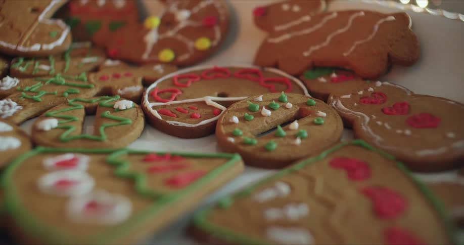 Iced christmas gingerbread cookies lay on white tray