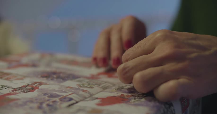 Woman puts tape on a wrapped present