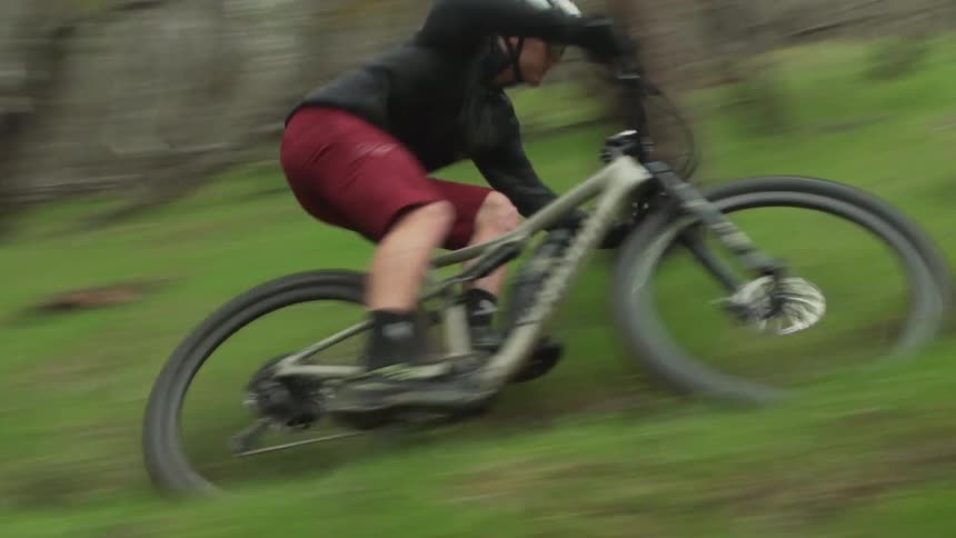 Man driving a mountain bicycle on a trail through the forest