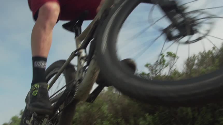 A man mountain biking down a hill