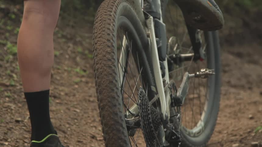 A person rides their mountain bike in the dirt