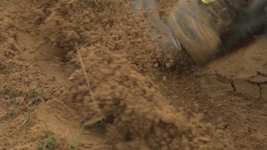 Cross country mountain bicycle tires rolling over loose soil