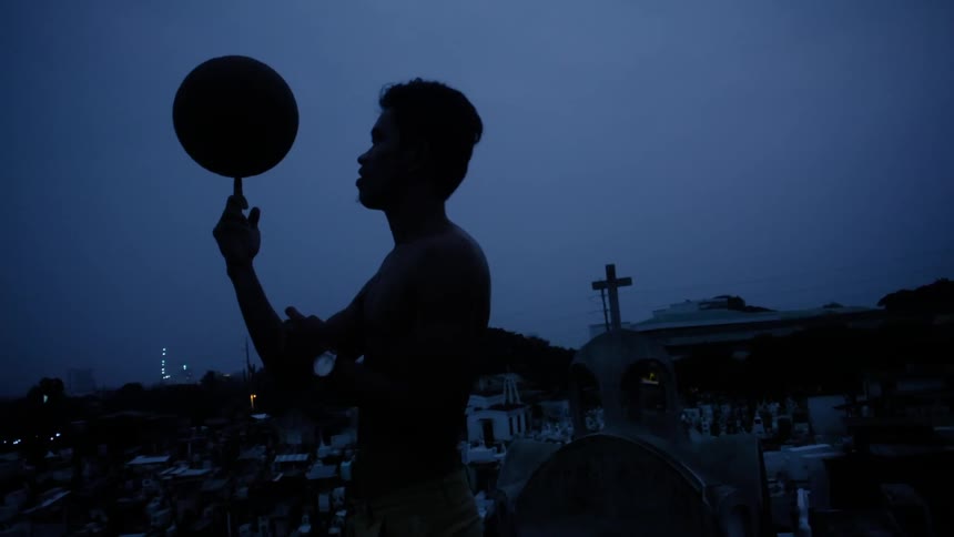 A man spinning a basketball on his finger