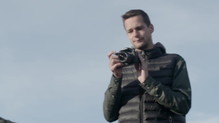 A man aims his camera to take a photograph