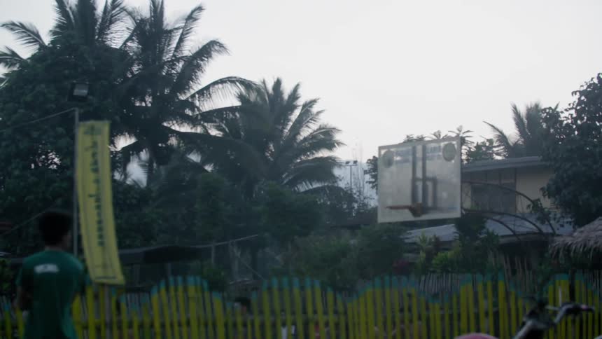 Passing view of children looking at others that are playing on a playground