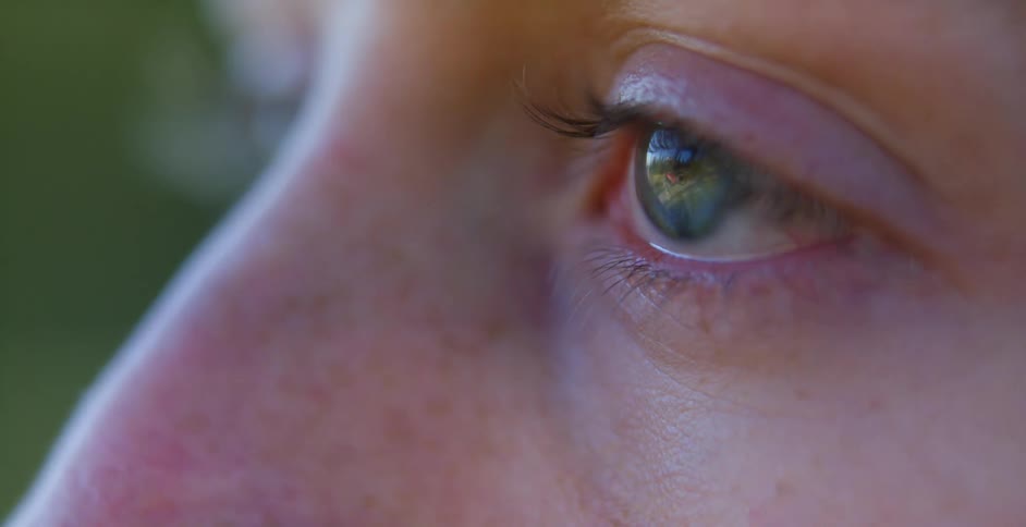 Reflection from a persons eye of a bike rider riding by
