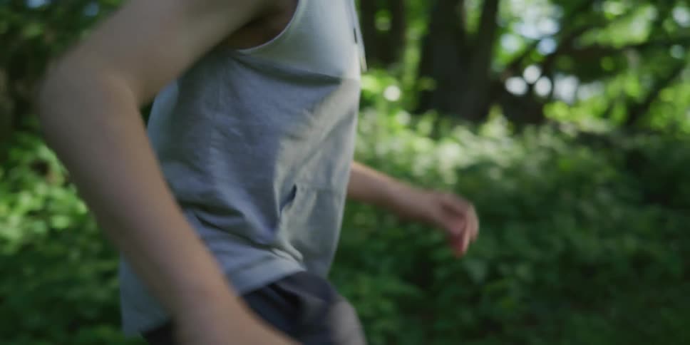 A young boy walking in a forest