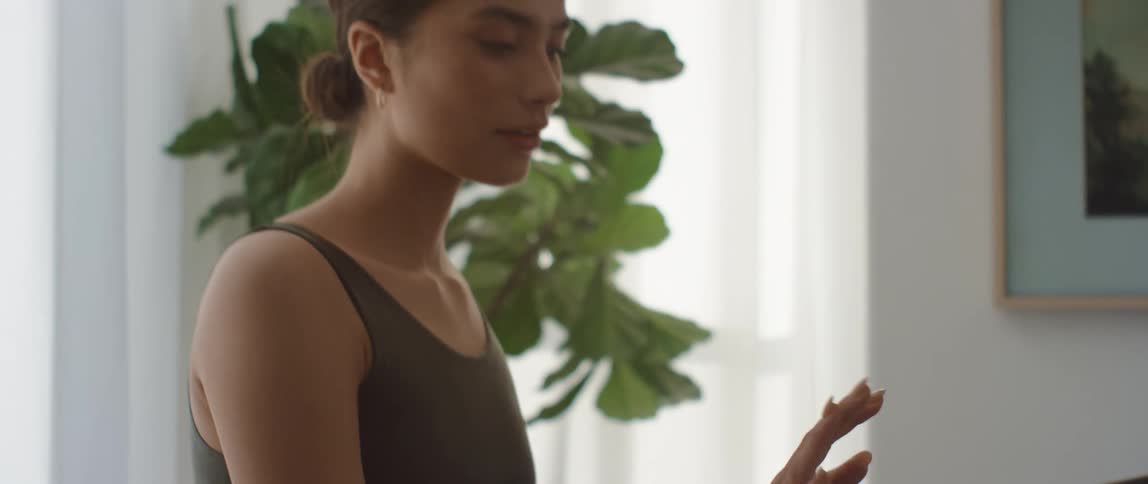 A female caucasian swiping on a computer screen as she smiles