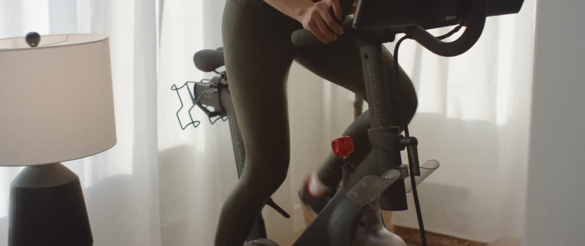 Woman exercising on a stationary bike indoors