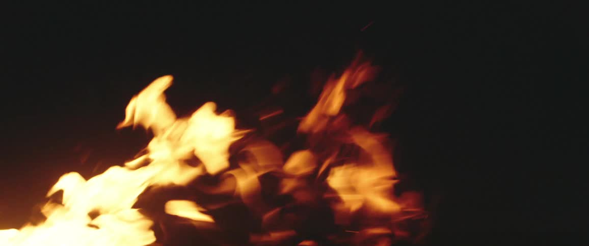 Flames from a campfire taller in the wind