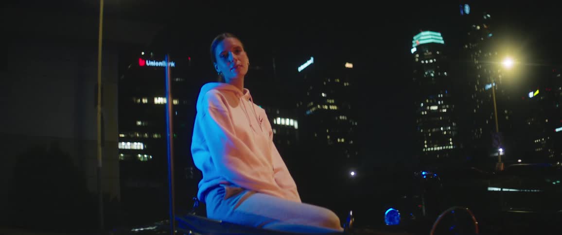 A woman is sitting in a building in a downtown city