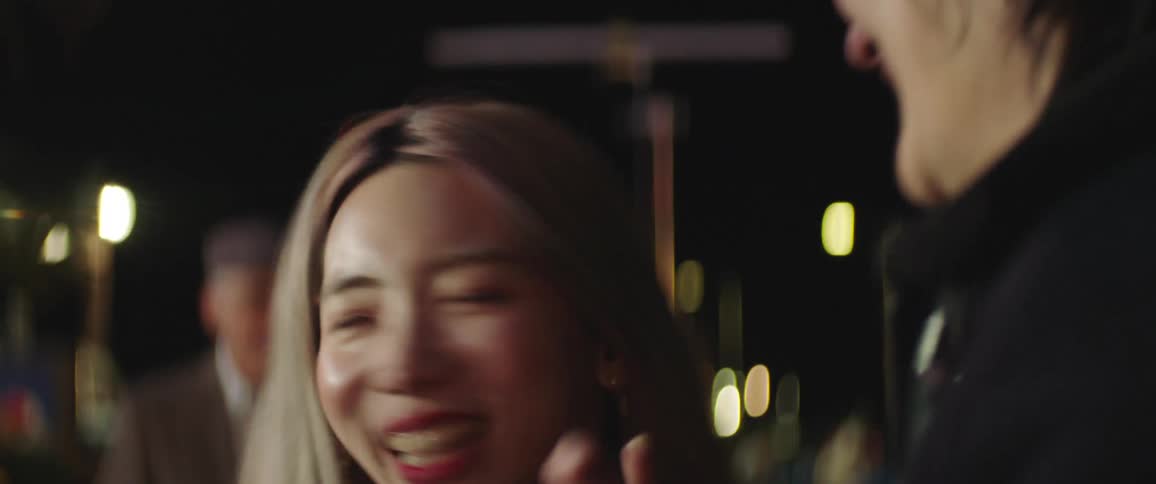 Couples stand around dancing and enjoying themselves