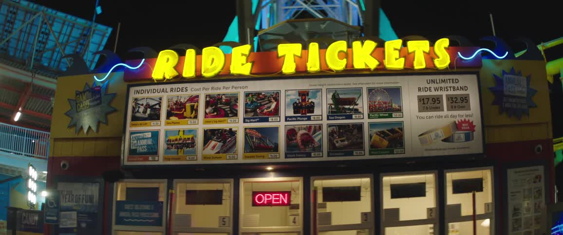 A ticket shop in a carnival with doors windows and signs