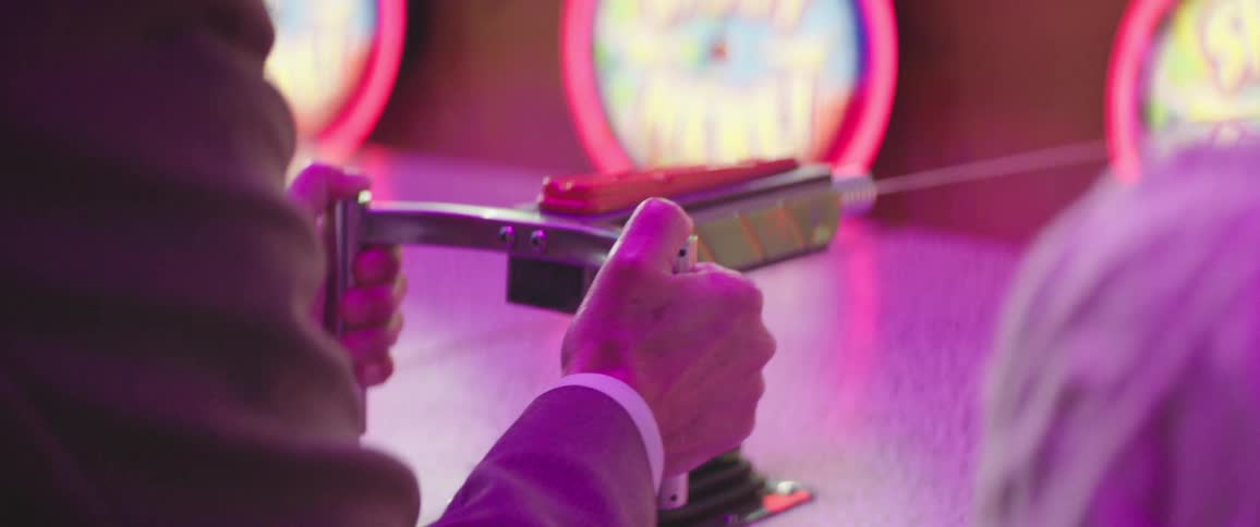 A person squirts water to play a carnival game