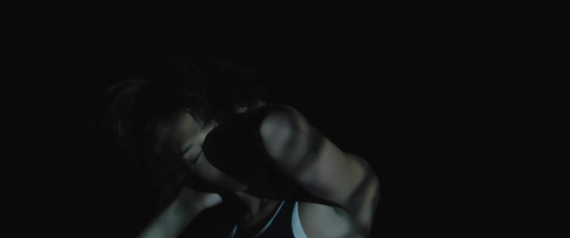 A woman is standing outdoors at night