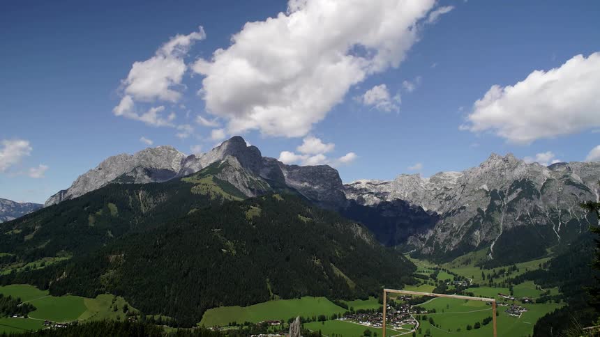 Time lapse of clouds forming and rolling over the peaks of a mountain range