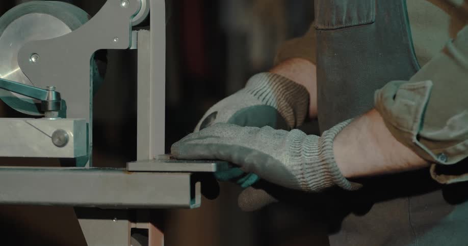A worker using a grinder
