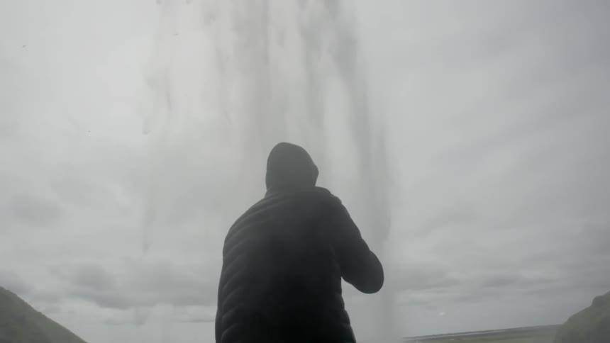 A man standing near a geyser