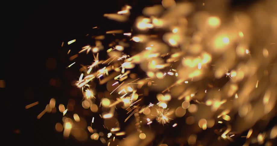 Flames and sparks outside at night