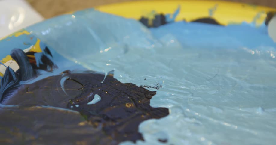 Black blue white and yellow colors that look like dry paint