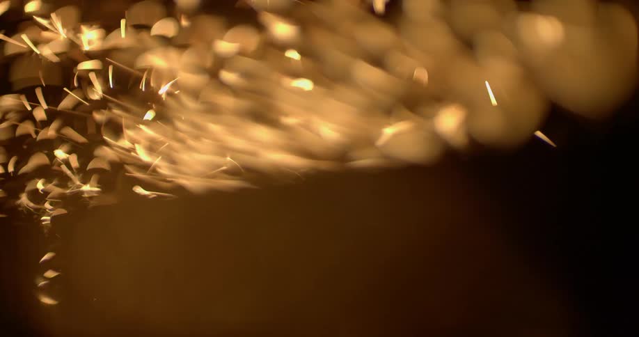 Sparks and glints swirl among darkness