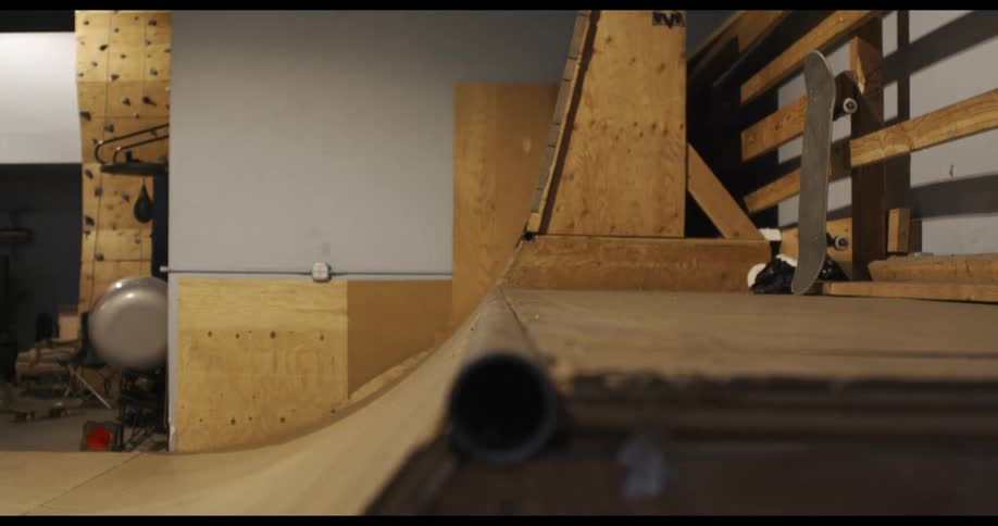 A man is skateboarding indoors
