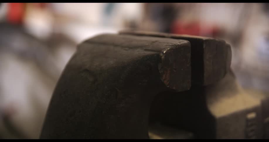 A plank of wood slamming in to a vise