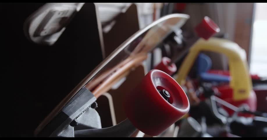 A skateboard hung up with a wheel spinning