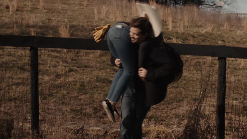 Man lifts woman over his shoulder and runs off with her