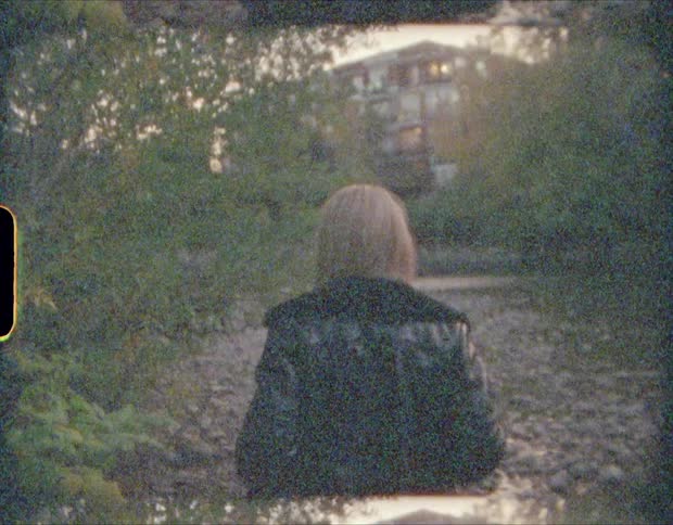 A film strip of a woman walking along a river