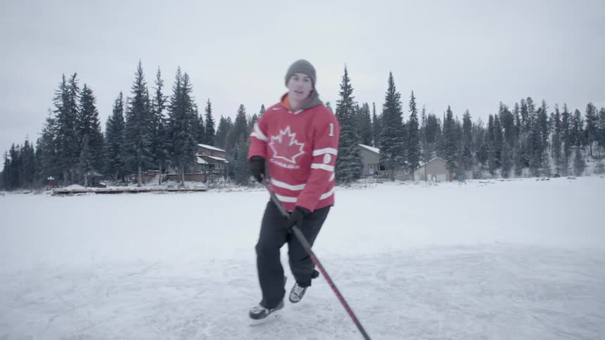 Young man playing hockey on an outdoor rink