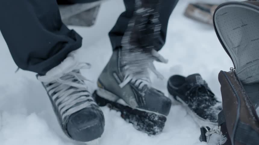 A person is tying their ice skates on