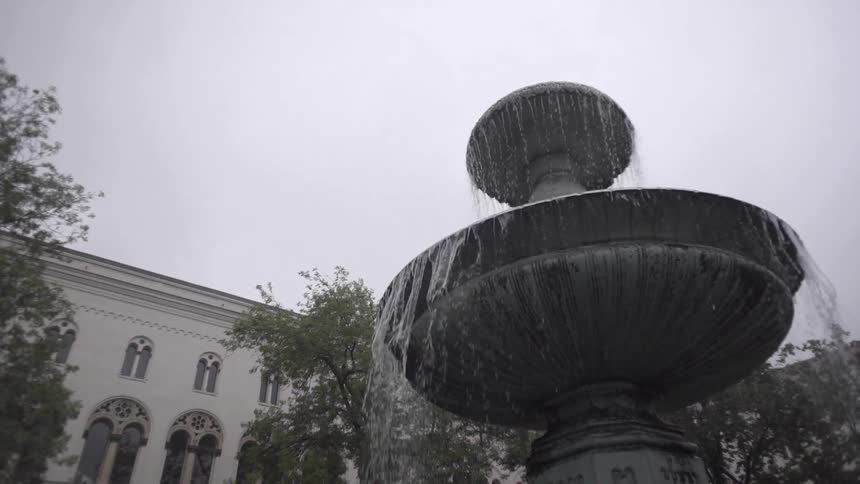 Water cascades over the sides of a stone fountain