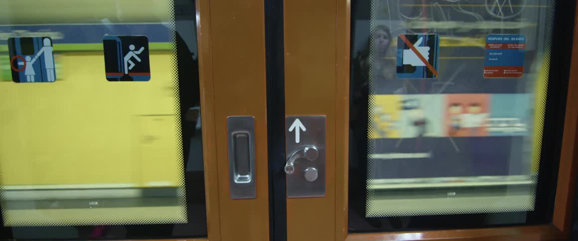 A subway platform with people walking on it is passed by a subway train