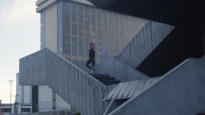 A woman is exercising in a downtown city