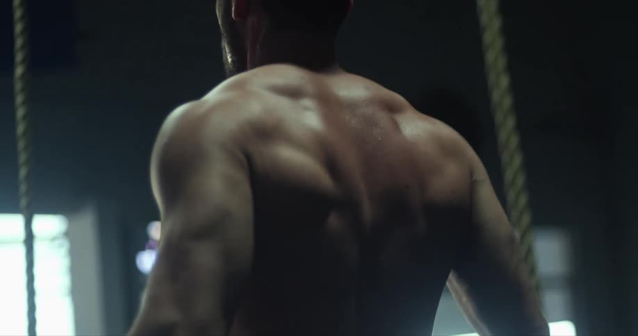 A man is exercising indoors during the day