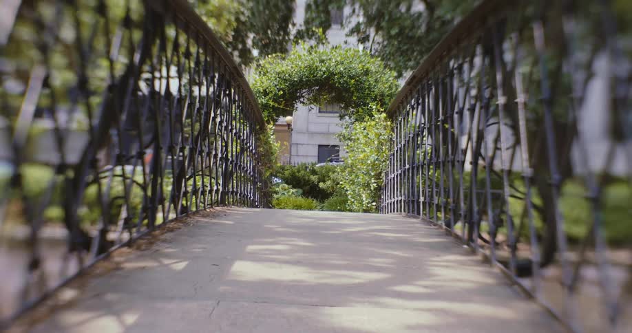 A walking narrow walking bridge in a city during the day