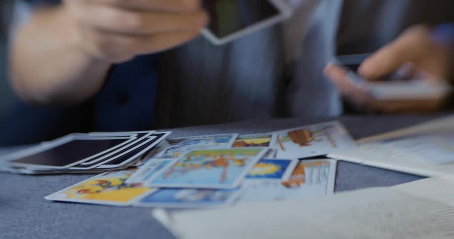 A man flips cards over on a table
