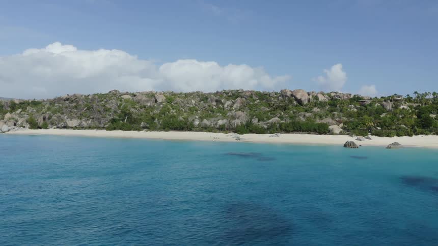 Aerial shot of boats by a costal beach