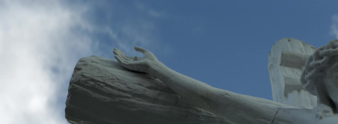 A statue of a person is outdoors during the day