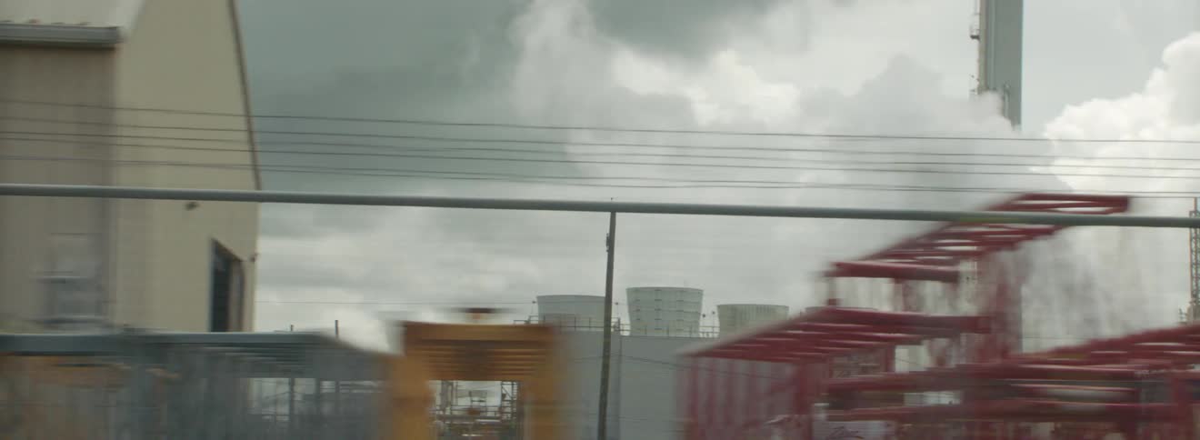 Power plant or factoring spewing smoke or steam in the industrial area of the city