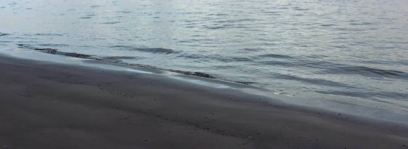 Tide coming in on a sandy shore on a beach