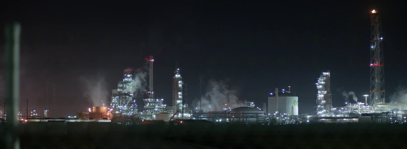A city skyline with buildings skyscrapers smoke and the sky