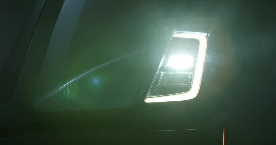 Close up of headlights turning on on a car